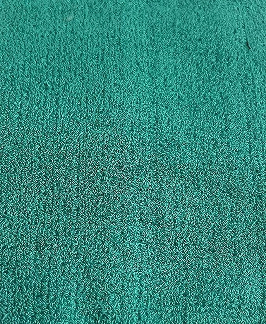 Close-up of a textured teal fabric surface