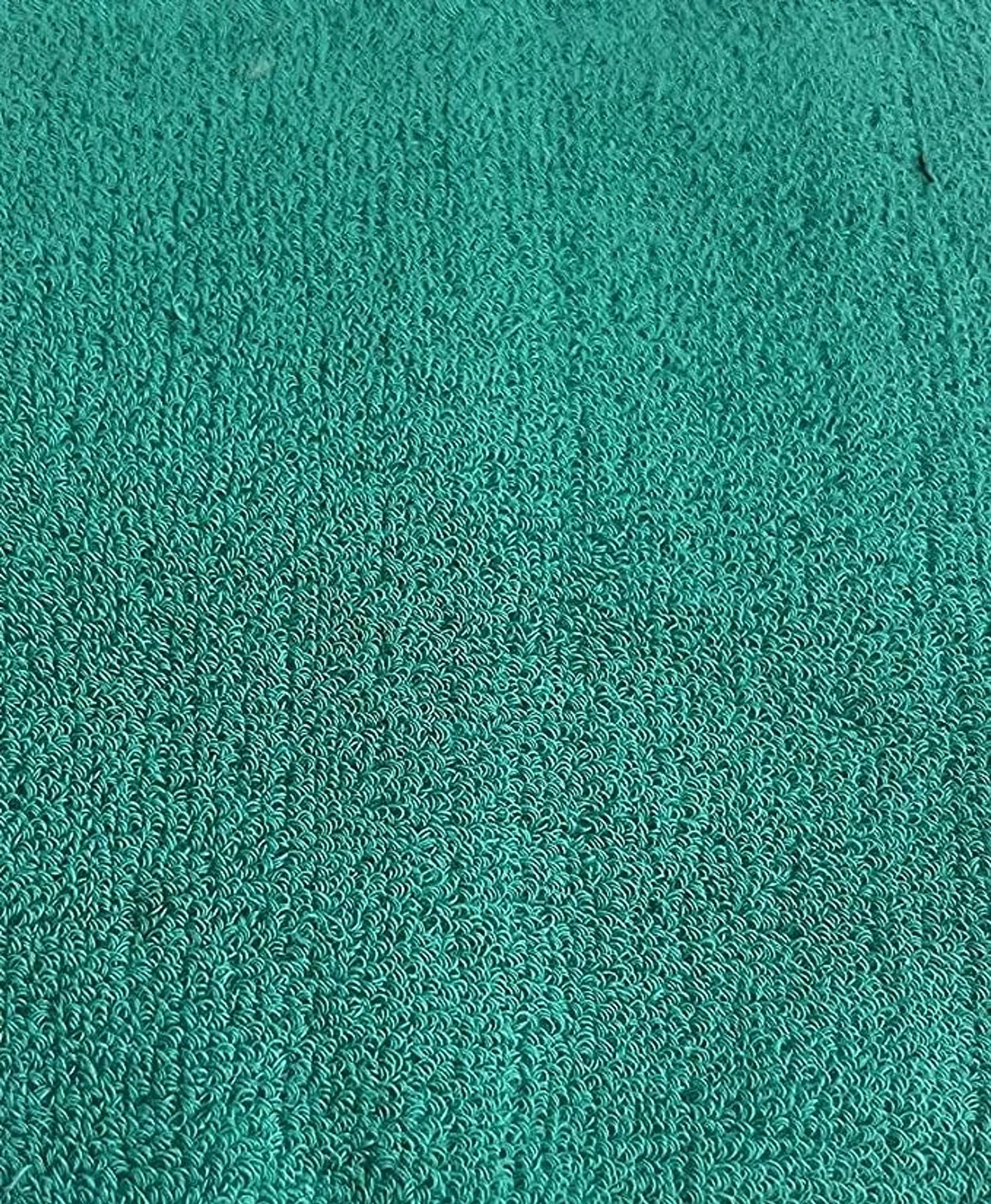 Close-up of a textured teal fabric surface